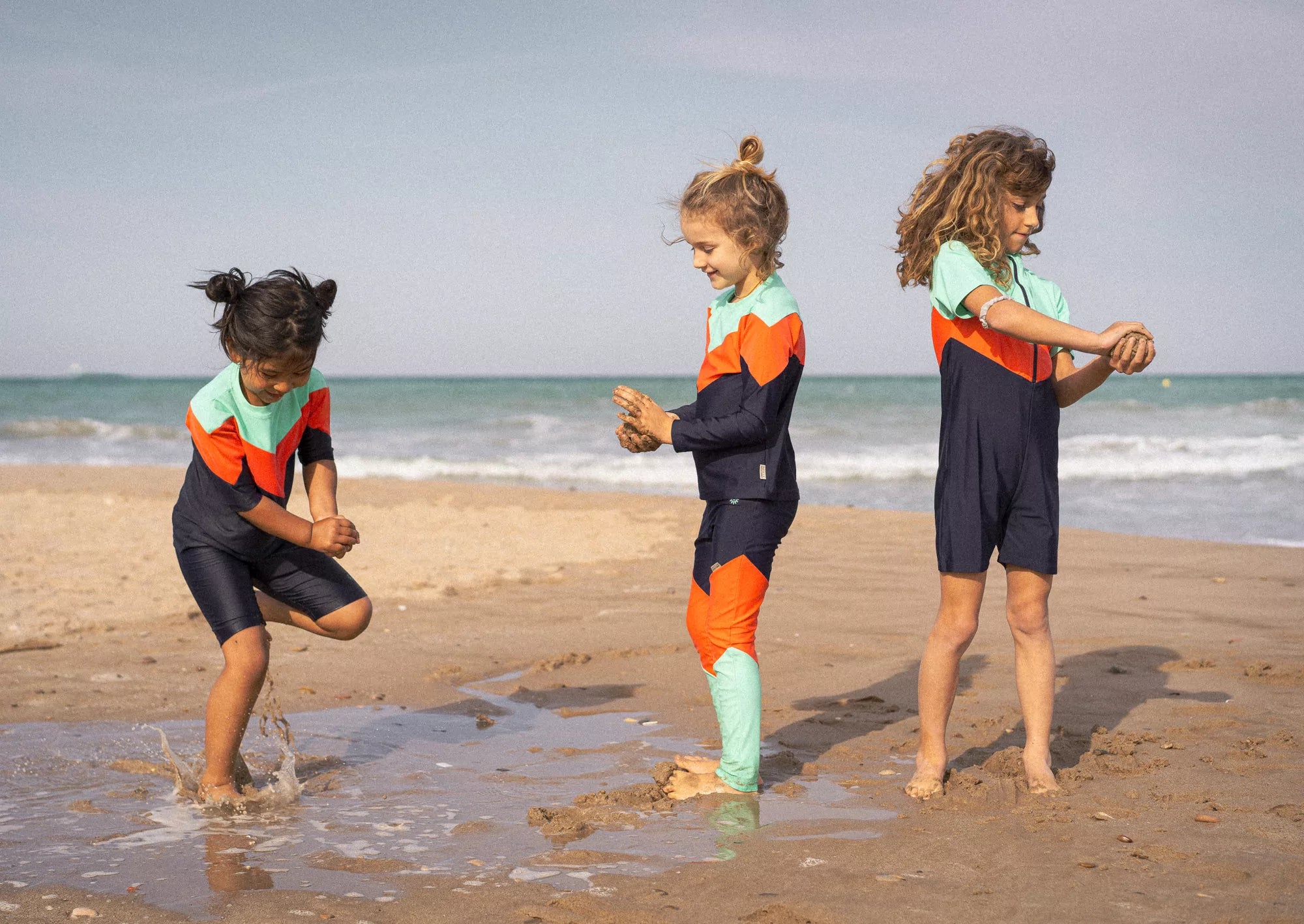 Kinder mit INASKA UV-Schutz T-Shirts und Leggings am Strand